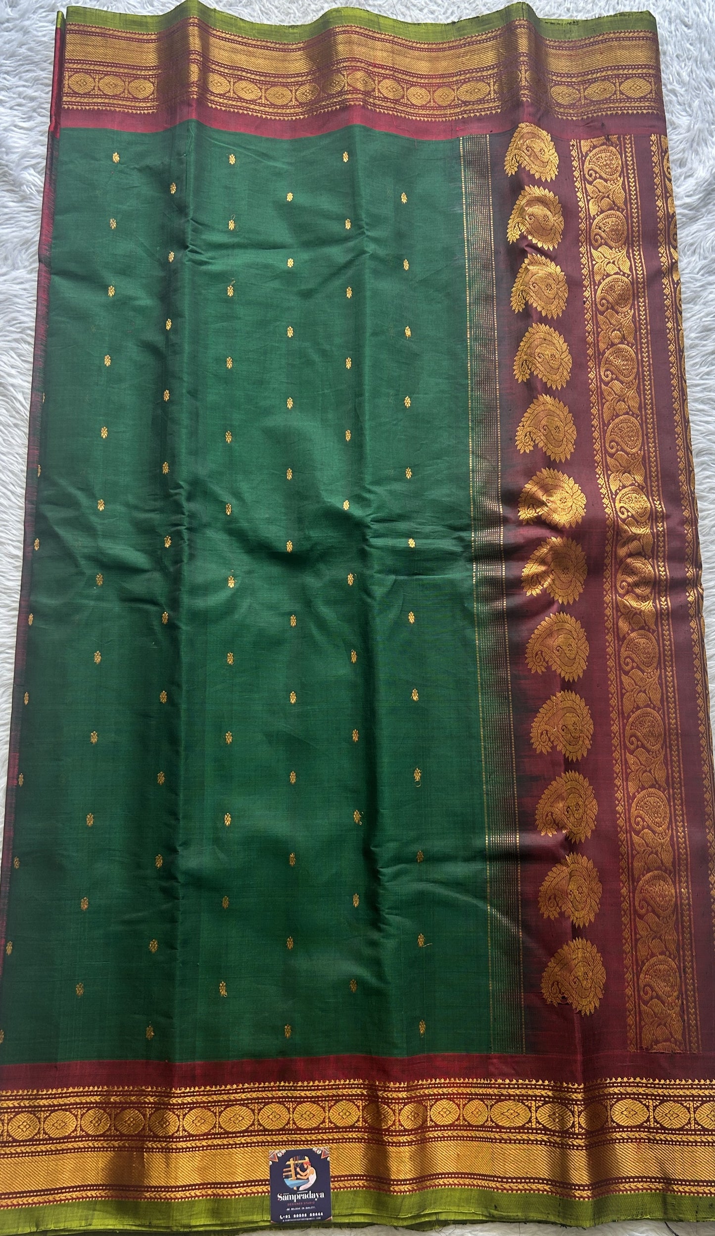 Gadwal Sico Saree Dark Green colored complemented with a Maroon Zari Border.