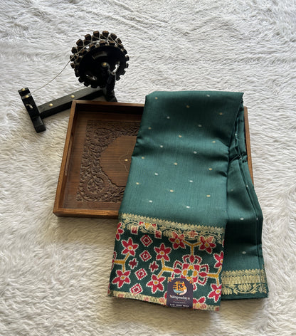 Pure Moonga Tussar Silk Saree Peacock Green Color Complemented with a Patolla Border.