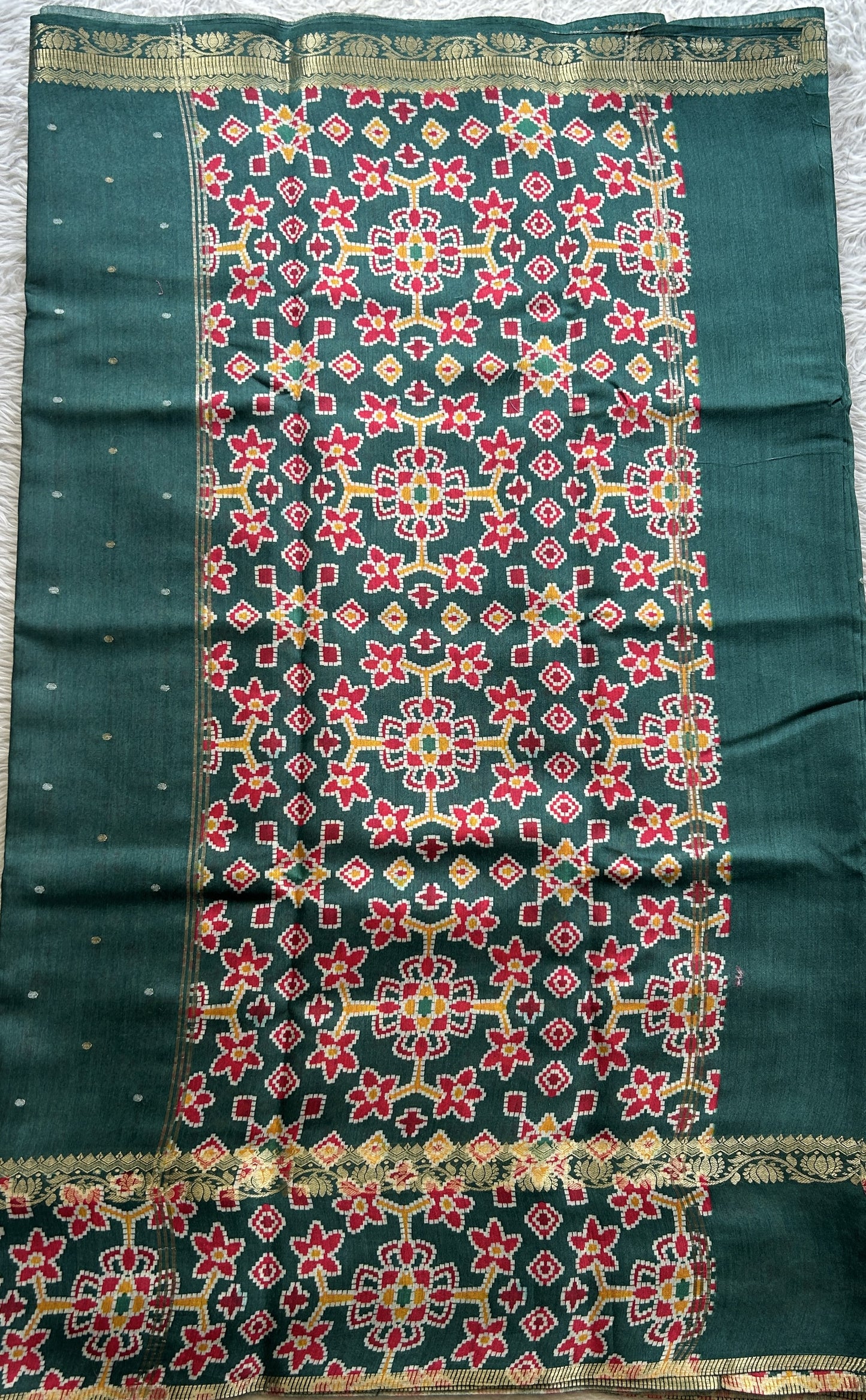 Pure Moonga Tussar Silk Saree Peacock Green Color Complemented with a Patolla Border.