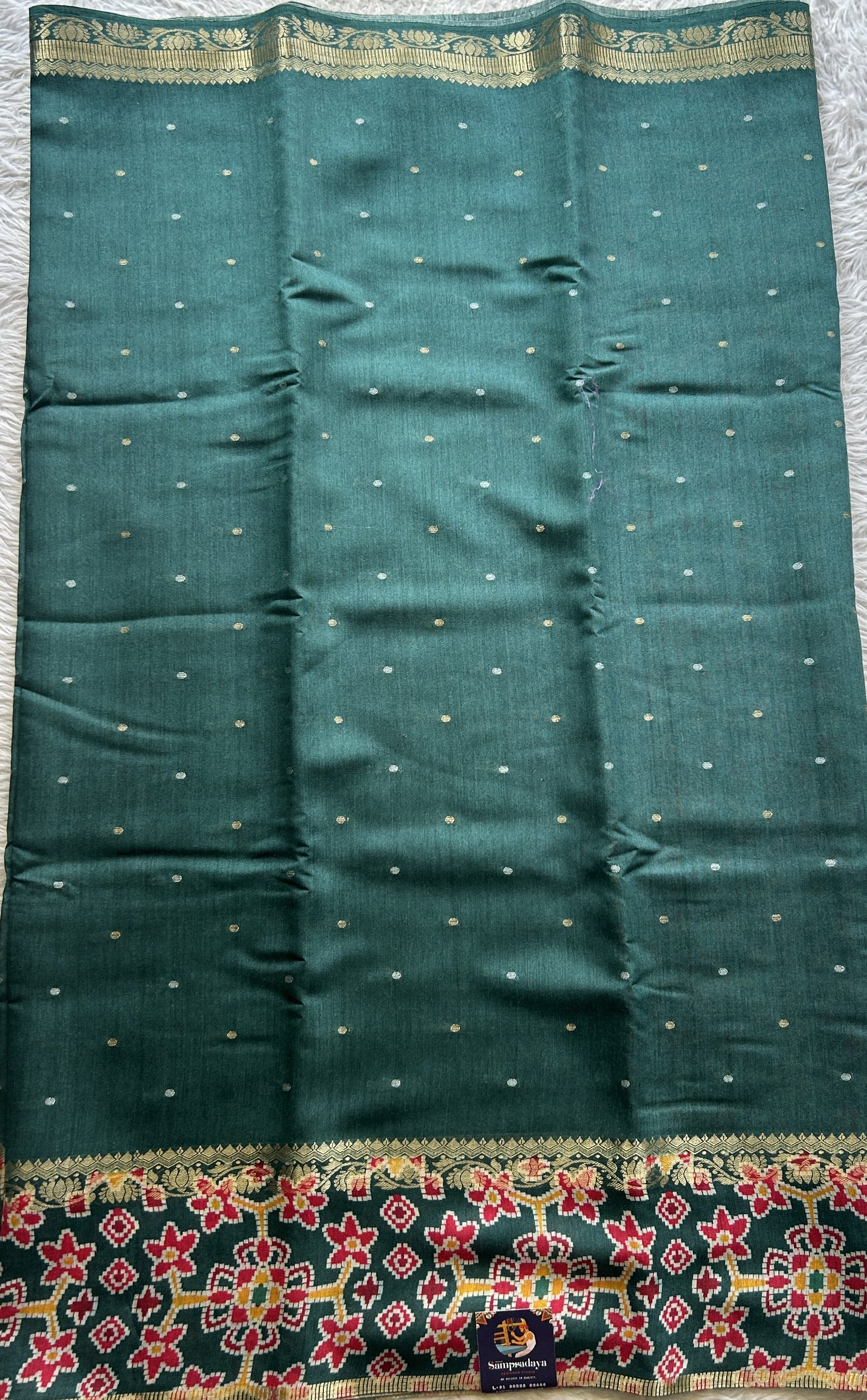 Pure Moonga Tussar Silk Saree Peacock Green Color Complemented with a Patolla Border.