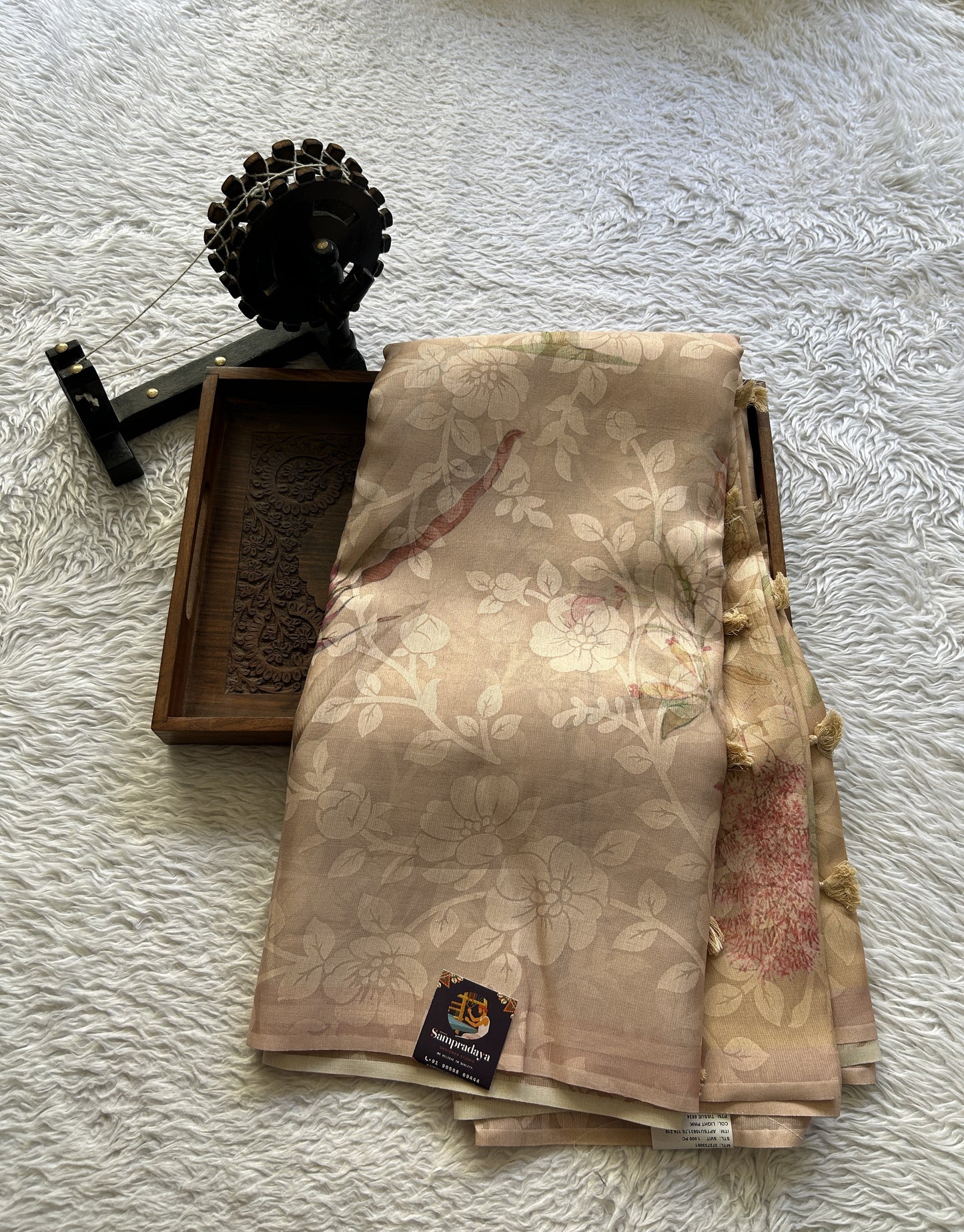 Banarasi Tissue Fancy Saree Light Peach Colored Paired with a Borderless.