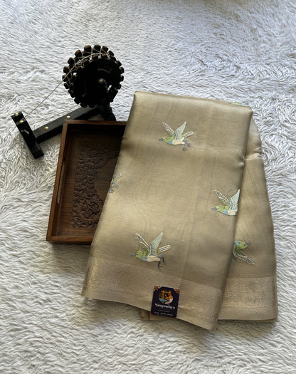 Banarasi Tissue Fancy Saree Beige Colored Paired with a Zari Border.