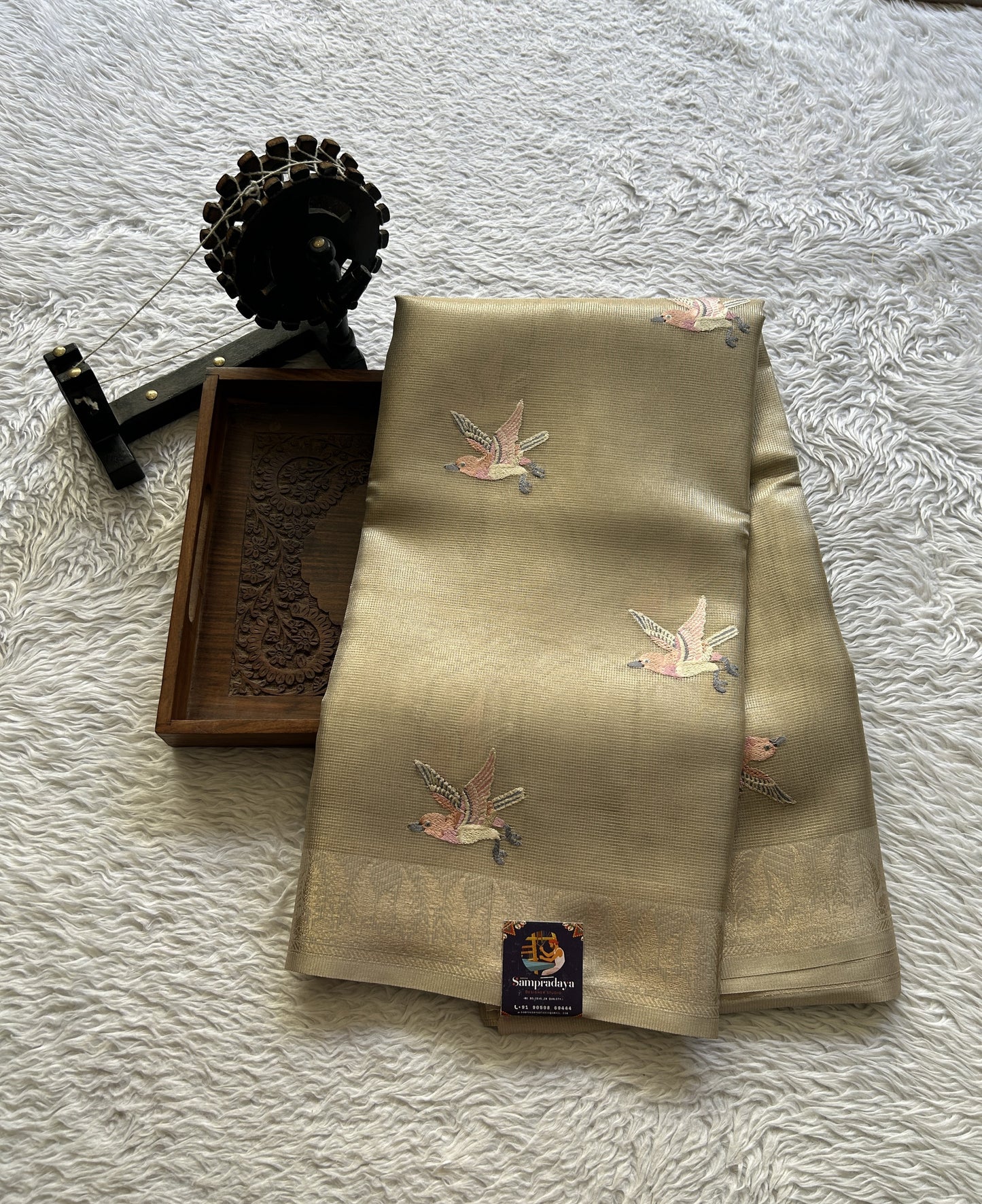 Banarasi Tissue Fancy Saree Biscuit Colored Paired with a Zari Border.