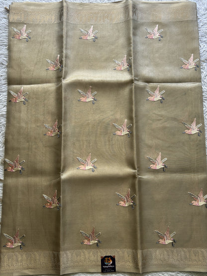 Banarasi Tissue Fancy Saree Biscuit Colored Paired with a Zari Border.