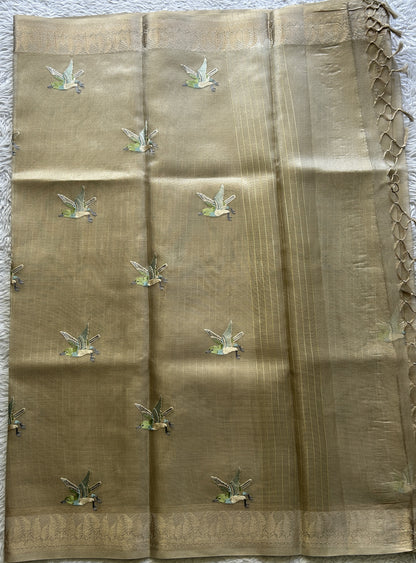 Banarasi Tissue Fancy Saree Beige Colored Paired with a Zari Border.