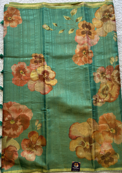 Banarasi Tissue Fancy Saree Rama Green Colored Paired with a Borderless.