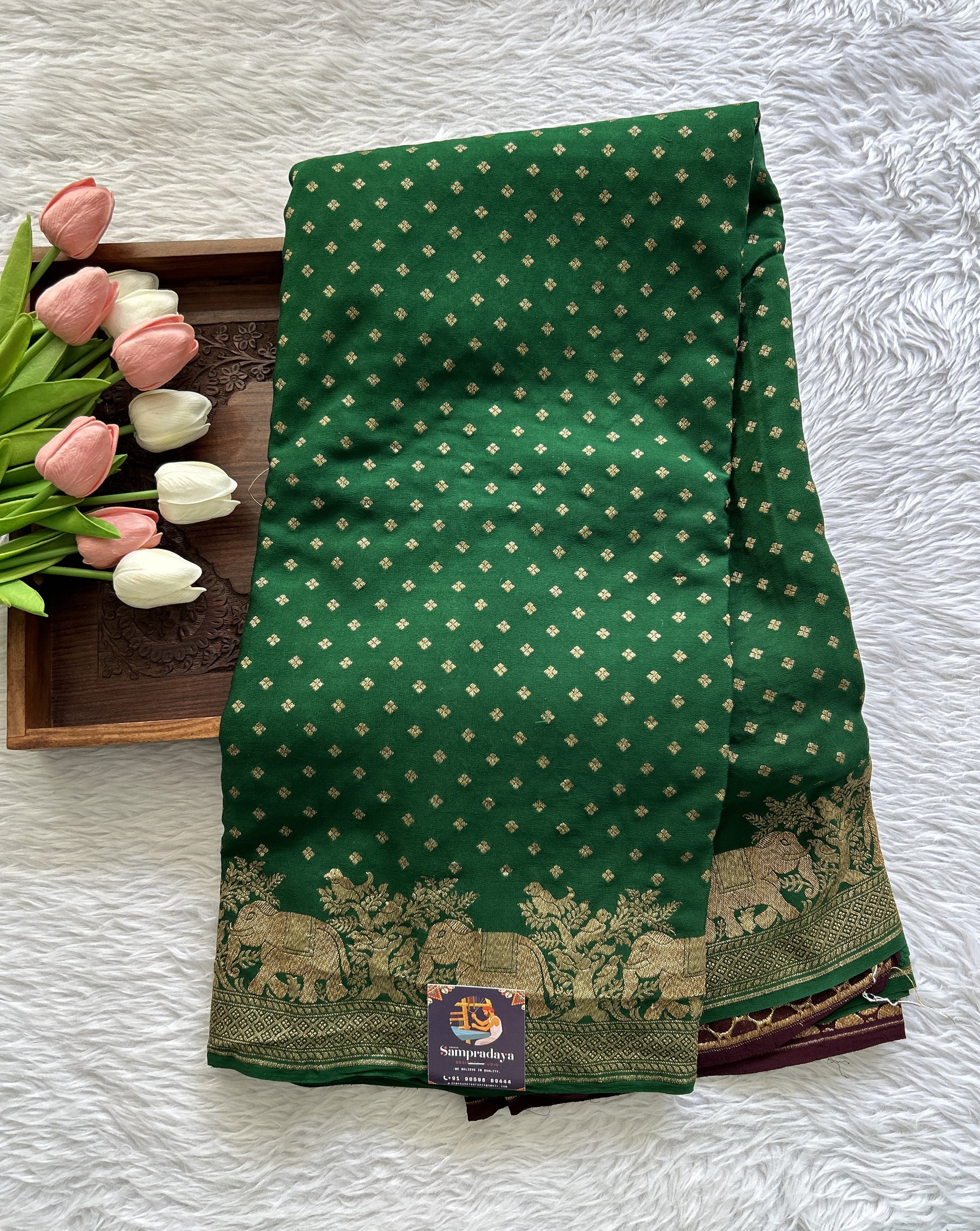 Banarasi Georgette Saree Green colored complemented with a Zari border. - Sampradaya Designer Studio