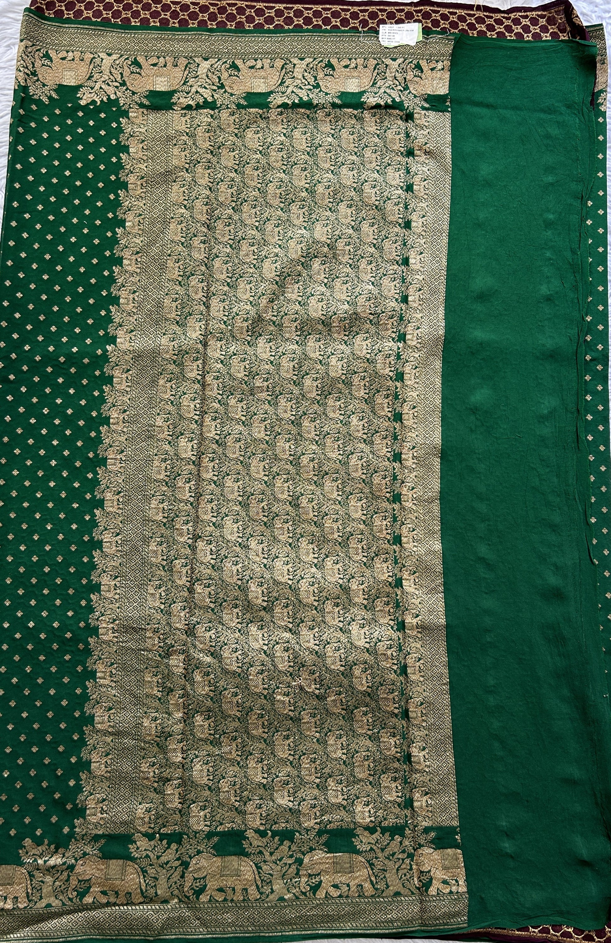 Banarasi Georgette Saree Green colored complemented with a Zari border. - Sampradaya Designer Studio