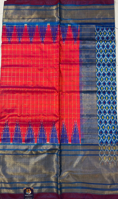 Ikkat Pattu Saree Pink Orange colored Saree complemented with a Blue Colored Kanchi border. - Sampradaya Designer Studio